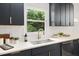 Bright kitchen featuring shaker cabinets, subway tile backsplash, and a stainless steel sink at 939 Clarion Dr, Durham, NC 27705