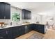 Well-lit kitchen featuring dark blue cabinetry, modern fixtures, and stainless steel appliances at 939 Clarion Dr, Durham, NC 27705