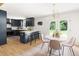 Kitchen and breakfast nook with modern lighting, black island, and French doors at 939 Clarion Dr, Durham, NC 27705