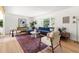 Open living room with hardwood floors, large windows, and a stylish blue sectional sofa at 939 Clarion Dr, Durham, NC 27705