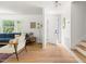 Bright living room featuring hardwood floors, a comfortable blue couch and white walls at 939 Clarion Dr, Durham, NC 27705