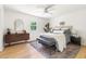 Calm bedroom with hardwood floors, a large window, and a comfortable king-sized bed at 939 Clarion Dr, Durham, NC 27705