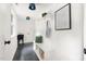 Mudroom features slate tile floor, bench with storage, open shelving, and modern lighting at 939 Clarion Dr, Durham, NC 27705