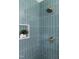Walk-in shower featuring stunning green tiling, a rain shower head, and a built-in niche at 939 Clarion Dr, Durham, NC 27705
