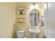 Charming powder room features an oval mirror, basin sink, and decorative animal art at 100 Arrowtown Way, Kenly, NC 27542