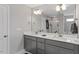 Elegant bathroom with double sinks, white countertop, large mirror, and modern fixtures at 100 Arrowtown Way, Kenly, NC 27542