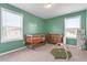 Cozy Bedroom featuring a crib, changing table, alphabet blocks, and a green accent wall at 100 Arrowtown Way, Kenly, NC 27542