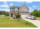 Charming two-story home with gray siding, manicured lawn, and attached garage at 100 Arrowtown Way, Kenly, NC 27542