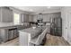 Modern kitchen featuring stainless steel appliances and a large center island with seating at 100 Arrowtown Way, Kenly, NC 27542