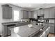 Spacious kitchen with gray cabinets, stainless appliances, and granite countertops at 100 Arrowtown Way, Kenly, NC 27542