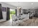 Open kitchen and dining area with gray cabinets, stainless appliances, and lots of light at 100 Arrowtown Way, Kenly, NC 27542