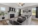 Comfortable living room featuring a fireplace, TV, and a large sectional sofa at 100 Arrowtown Way, Kenly, NC 27542