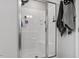 Modern shower with glass door, showerhead, and shelving to keep essentials organized at 100 Arrowtown Way, Kenly, NC 27542
