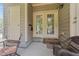 Cozy back patio with double doors, offering a serene spot for outdoor enjoyment and relaxation at 100 Tobacco Leaf Ln, Apex, NC 27502