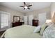 Spacious bedroom featuring hardwood floors, a ceiling fan, and abundant natural light at 100 Tobacco Leaf Ln, Apex, NC 27502