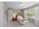 Bedroom with a wooden nightstand, white bedding, and natural light from the window at 100 Tobacco Leaf Ln, Apex, NC 27502