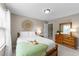 Bedroom showcasing a wooden bed, soft white bedding, and wooden dresser at 100 Tobacco Leaf Ln, Apex, NC 27502