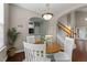 Cozy dining area featuring a round table, white chairs, and stylish decor, with an archway to the kitchen at 100 Tobacco Leaf Ln, Apex, NC 27502