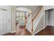 Inviting entryway with hardwood floors, staircase, and open view of the dining area with abundant natural light at 100 Tobacco Leaf Ln, Apex, NC 27502