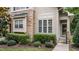 Detailed view of the townhouse exterior highlighting the stone accents and front door at 100 Tobacco Leaf Ln, Apex, NC 27502