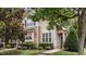 Charming two-story townhouse with stone accents, manicured landscaping, and welcoming front entrance at 100 Tobacco Leaf Ln, Apex, NC 27502