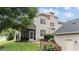 Rear exterior view of the house with screened in porch, lush lawn and manicured landscaping at 100 Tobacco Leaf Ln, Apex, NC 27502