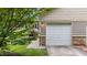 Attached two-car garage featuring neutral siding and stone accents, complete with a lush landscaped front yard at 100 Tobacco Leaf Ln, Apex, NC 27502
