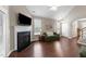 Living room with fireplace and modern finishes with wood floors and natural light at 100 Tobacco Leaf Ln, Apex, NC 27502