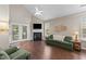 Bright and airy living room showcasing fireplace, wood floors, and neutral color scheme at 100 Tobacco Leaf Ln, Apex, NC 27502
