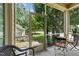 Relaxing screened porch featuring outdoor seating with views of the home's manicured lawn and surrounding greenery at 100 Tobacco Leaf Ln, Apex, NC 27502