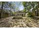 A view of the backyard with trees surrounding the house and lawn at 1022 Dorothea Dr, Raleigh, NC 27603