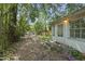 Backyard area with a path leading to another building in the distance, enhanced by flowers and lush greenery at 1022 Dorothea Dr, Raleigh, NC 27603