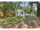 Landscaped backyard with mature trees, flowers, and grass at 1022 Dorothea Dr, Raleigh, NC 27603