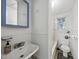 Functional white bathroom featuring a sink, mirror, shower, and toilet, designed for everyday convenience at 1022 Dorothea Dr, Raleigh, NC 27603