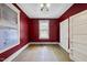 An empty bedroom with hardwood floors, two windows with blinds, and red walls at 1022 Dorothea Dr, Raleigh, NC 27603