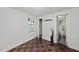 Well-lit bedroom with unique checkered floors that leads to a closet and a bathroom, creating a cozy atmosphere at 1022 Dorothea Dr, Raleigh, NC 27603