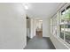 Hallway features white walls, windows, and a doorway leading to another room at 1022 Dorothea Dr, Raleigh, NC 27603