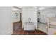Living room with a small kitchen area featuring black and red tile flooring at 1022 Dorothea Dr, Raleigh, NC 27603