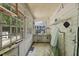 Sunroom with multiple windows, tile floors, and shelving units at 1022 Dorothea Dr, Raleigh, NC 27603