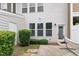 Cozy patio with a hammock surrounded by well-maintained shrubs and a private fence at 103 Ransomwood Dr, Apex, NC 27539