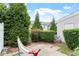 Cozy patio with a hammock surrounded by mature landscaping and a private fence at 103 Ransomwood Dr, Apex, NC 27539