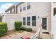 Cozy patio with a hammock surrounded by well-maintained shrubs and a private fence at 103 Ransomwood Dr, Apex, NC 27539