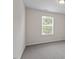 Bright bedroom features neutral walls and carpet with a large window at 103 Ransomwood Dr, Apex, NC 27539