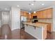Well-lit kitchen featuring stainless steel appliances, wood cabinets, and an island with granite countertop at 103 Ransomwood Dr, Apex, NC 27539