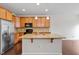 Bright kitchen with granite countertops, stainless steel appliances, and a central island with a sink at 103 Ransomwood Dr, Apex, NC 27539