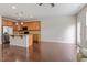 Open-concept living room with hardwood floors connected to a kitchen with granite countertops and wood cabinets at 103 Ransomwood Dr, Apex, NC 27539