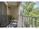 Cozy balcony features a charming bench, potted plants, and a serene outdoor view at 10310 Sablewood Dr # 211, Raleigh, NC 27617