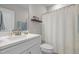 Bright bathroom with white vanity, updated fixtures, and a shelf for decor at 10310 Sablewood Dr # 211, Raleigh, NC 27617