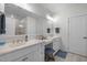 Bright bathroom with dual sinks, a vanity area, and modern fixtures at 10310 Sablewood Dr # 211, Raleigh, NC 27617