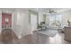 Office/bedroom area with hardwood floors, large windows, and an accent wall at 10310 Sablewood Dr # 211, Raleigh, NC 27617
